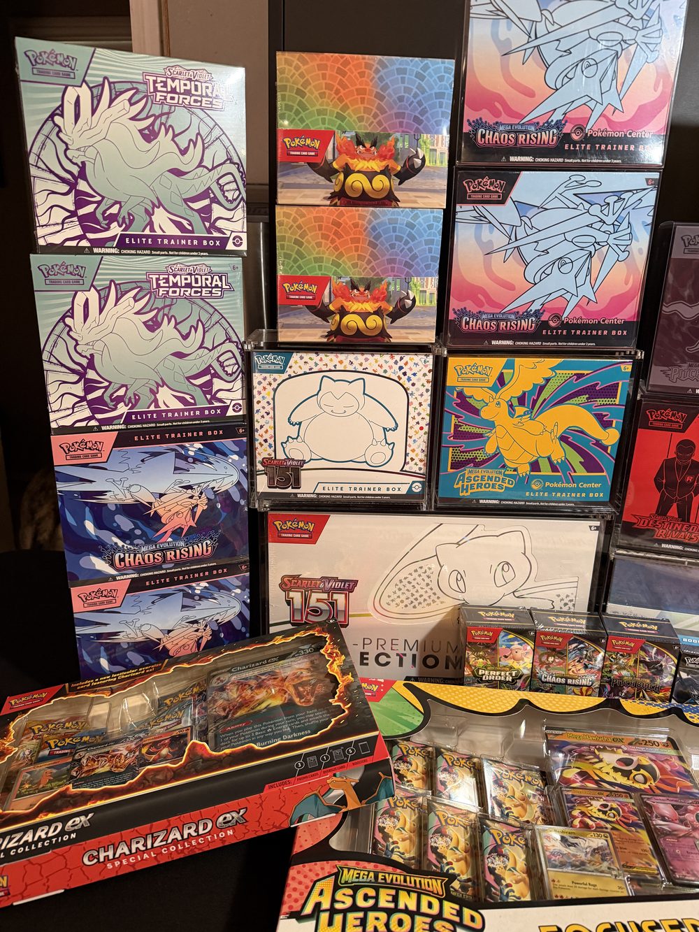 Sealed Pokemon TCG product, including Elite Trainer Boxes and booster boxes.